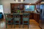 Fully stocked kitchen with stainless appliances and granite counters